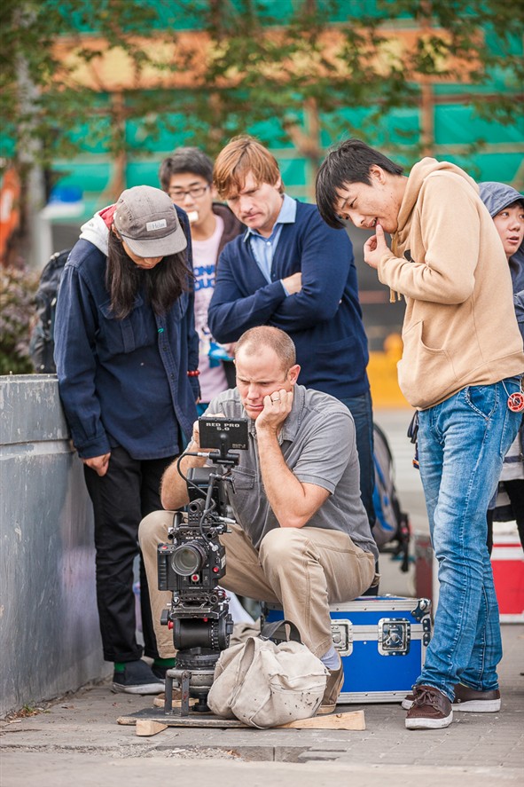 Suzhou production crew reviewing a shoot on location